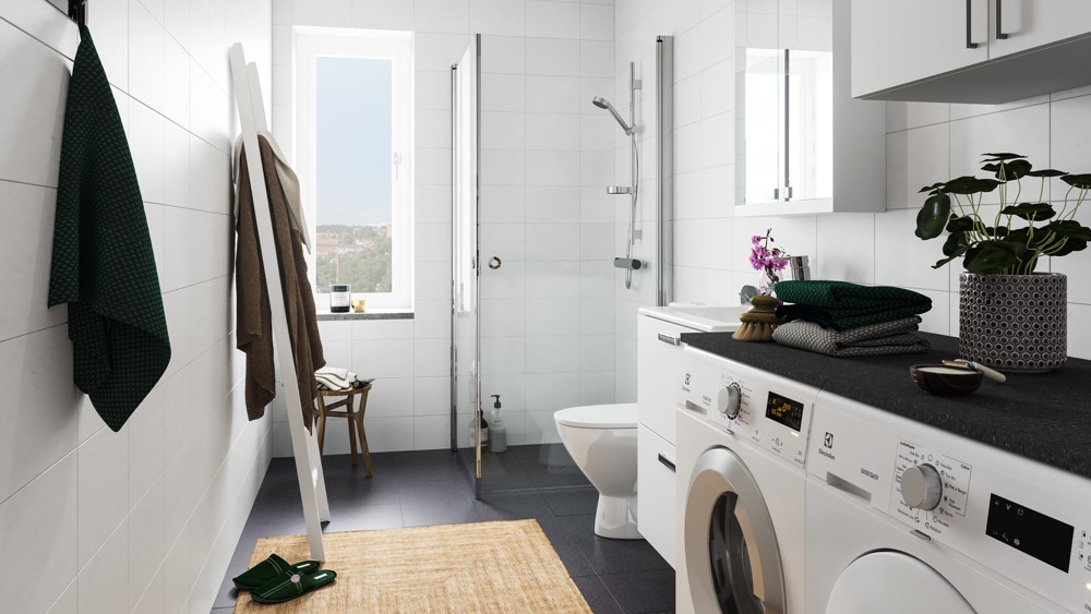 helkaklat vitt badrum med tvättmaskin och torktumlare